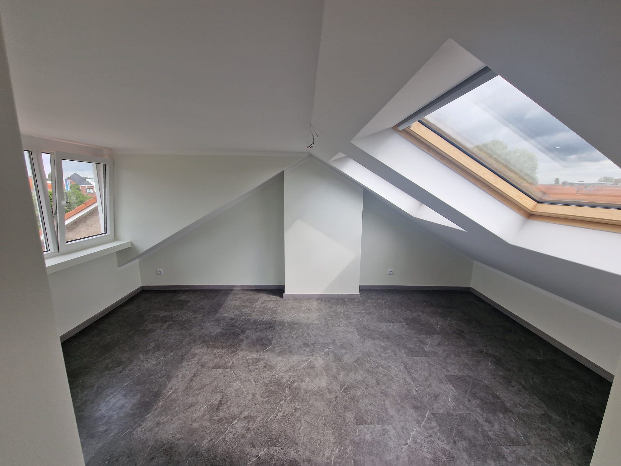 afgewerkte zolderkamer met Velux, vloerbedekking